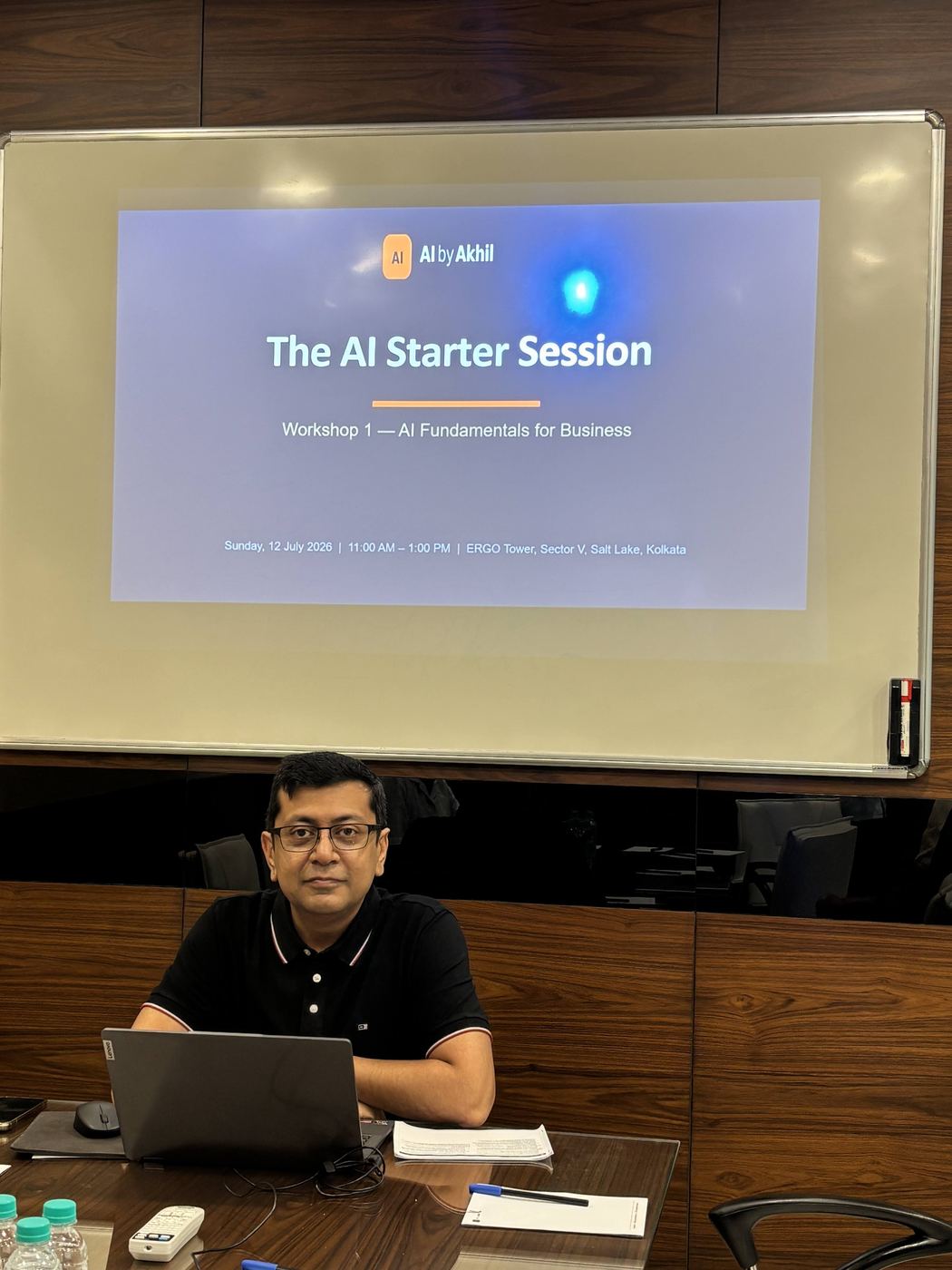 Akhil at the front of the room before a session begins
